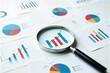 © AiGalaxy - A magnifying glass rests on a table with graphs and charts