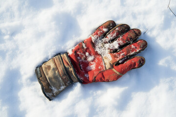 Winter gloves lying in the snow.