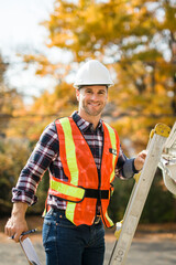 Wall Mural - man with hard hat standing on steps inspecting house roof