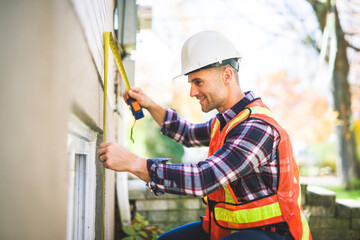 Wall Mural - Man inspecting house window outside on day light