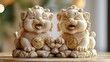 © Myint - Two smiling lion figurines with intricate details and golden embellishments