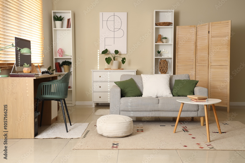 Interior of living room with workplace, sofa and shelf units