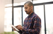 © peopleimages.com - Creative, startup and man in office with tablet for online reviews, research and insights feedback. Employee, business project and social media manager browsing on internet or website for networking