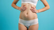 © igor.nazlo - No filter cropped photo of lady tummy underwear apply anti stretching marks cream empty space isolated blue color background
