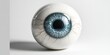 © amelisk - Close-up of a fake eyeball with a blue iris, showcasing artificial design and detail. High resolution image for illustrative purposes.