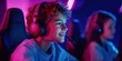 © Kamonwan - Young boy enjoying video games with headphones on in a vibrant, colorful gaming room environment.