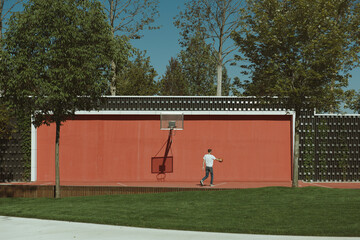 Young man playing basketball in the park, Concept of sport and recreation