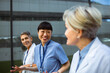 © Marko Geber - Happy medical team socializing outside hospital during break