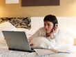 © Designpics - Businesswoman Working in Hotel Room
