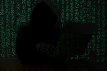 hacker over a screen with binary code. concept of a hacker attack