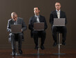 © Designpics - Three Businessmen Using Laptop Computers