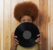 © Designpics - Woman Holding Record