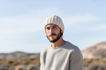 Sticker - Portrait of a tender man in his 30s donning a warm wool beanie isolated in light wood minimalistic setup