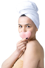 Wall Mural - Beauty portrait of woman in white towel on head  with a sponge for a body in view of a pink heart. Skincare cleansing eco organic cosmetic spa relax concept.