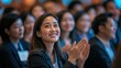 © David Zarzosa - Smiling Woman Applauding at Business Conference with a diverse audience.