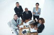 © peopleimages.com - Business people, portrait and collaboration with tech and public relations with teamwork in office. Above, employee internet with paperwork, staff and discussion with laptop and feedback review