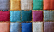 © eshana_blue - Close-up of a colorful patchwork fabric, showcasing various textures and stitching details, creating a vibrant and visually appealing background
