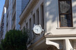 © Sinan - a round clock on the facade of the building showing the evening time