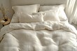 © olegganko - Soft white bedding neatly arranged on a comfortable bed in a serene bedroom setting