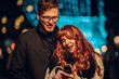 © Zamrznuti tonovi - A festive couple is texting messages and wishing happy new year on street.