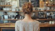 © olegganko - Young woman with long hair in casual attire smiling in a coffee shop during the day