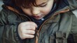 © Ytnart - A young child zipping up a stylish jacket, showcasing warmth and comfort, perfect for seasonal themes.