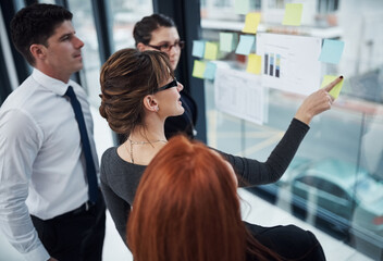 Employees, sticky notes and ideas on glass in office, brainstorming and finance staff for budget. Business people, graphs and vision for income growth, coworking and solution for expenses in meeting