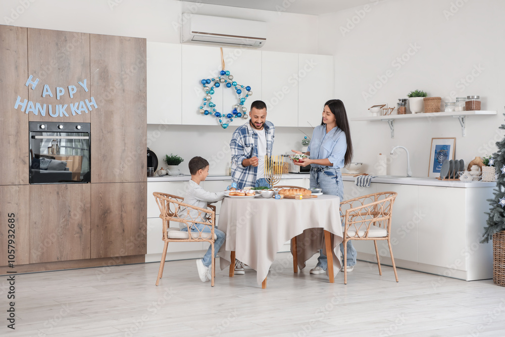 Happy family having dinner in festive kitchen with decorations for Hanukkah celebration