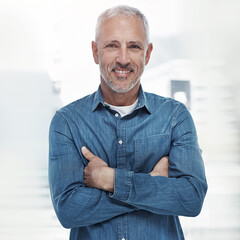 Arms crossed, portrait and smile of business man in creative workplace for management of design company. Confident, casual and denim with happy mature employee in office for career development