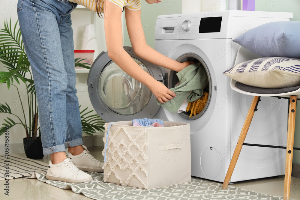 Young woman doing laundry in room