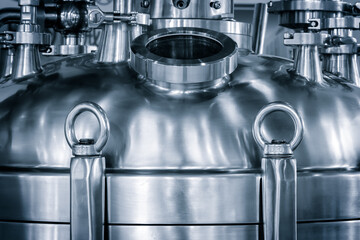 Poster - A silver metal container with a metal ring on top. container is shiny and metallic. The ring is attached to the container and is hanging down, chemical pharmaceutical concept background