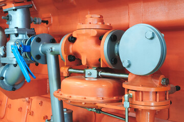 Aufkleber - Large orange piston gas engine electric generator with many valves and pipes. The engine is orange and has many valves.