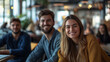 © Creator - Three people, two men and one woman, smiling at the camera in a cafe