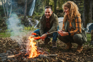 hiker couple enjoy on the camp while grill and eat sausage