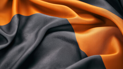 Wall Mural - Close-up of black and orange fabric with soft folds and textures creating a striped pattern