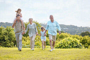 Wall Mural - Family, generations and holding hands in park with kids, smile and outdoor fun on weekend morning together. Grandparents, dad and girl children in garden for happy bonding, relax and love in nature