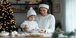 © Odin AI - A joyful mother and her young son enjoy making and decorating Christmas treats in their kitchen, surrounded by baking tools and holiday decorations.