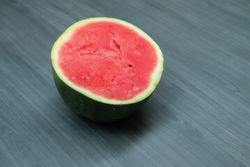 slices of red watermelon on a wooden background