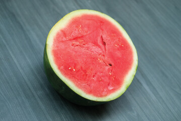 slices of red watermelon on a wooden background