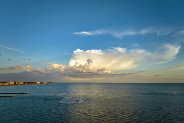 Canvas Print - Aerial view of sea shore near Venice, Florida with white yachts at sunset floating on sea waves. North and South Jetty on Nokomis beach. Motor boat recreation on ocean surface