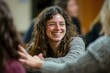 © Tharushi - A young caucasian woman smiling at her friends in a group therapy session supporting each other