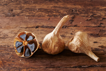 Wall Mural - Black garlic on old wooden board