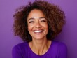 © MagicAI - Happy middleaged woman with curly hair, smiling brightly, against a purple background, Smiling portrait, Color backdrop