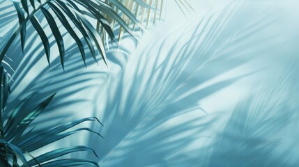 Poster - Abstract background created by blurred palm leaf shadow on pastel blue wall for seasonal product showcase.