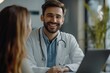 © Vooglo.com - Portrait of smiling male doctor at medical office in hospital, showing examination results