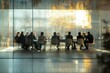 © Vooglo.com - A business meeting in progress, with professionals seated around a glass-walled