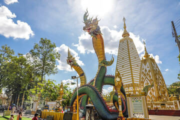 Wat Phra That Nong Bua, Ubon Ratchathani, inside there is the Phra That Sri Maha Bodhi Chedi, a replica of the Chedi in Bodh Gaya, India, stucco sculptures, candles, and two large Naga statues.