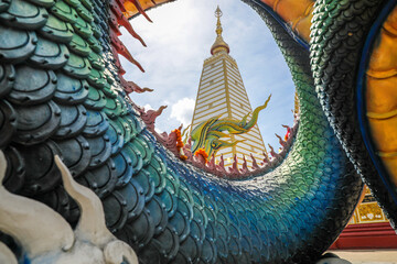 Wat Phra That Nong Bua, Ubon Ratchathani, inside there is the Phra That Sri Maha Bodhi Chedi, a replica of the Chedi in Bodh Gaya, India, stucco sculptures, candles, and two large Naga statues.