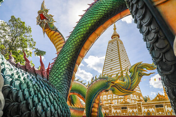 Wat Phra That Nong Bua, Ubon Ratchathani, inside there is the Phra That Sri Maha Bodhi Chedi, a replica of the Chedi in Bodh Gaya, India, stucco sculptures, candles, and two large Naga statues.