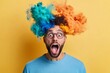 © Trusha - Man with a colorful wig, glasses is making funny face, opening his mouth wide. image is meant to be humorous lighthearted, with man's exaggerated expression, colorful appearance adding to comedic